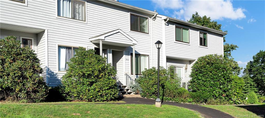442 Cypress Road, Unit 442 Newington, CT 06111 - Photo 1 of 1 a view of a white house with a yard and potted plants