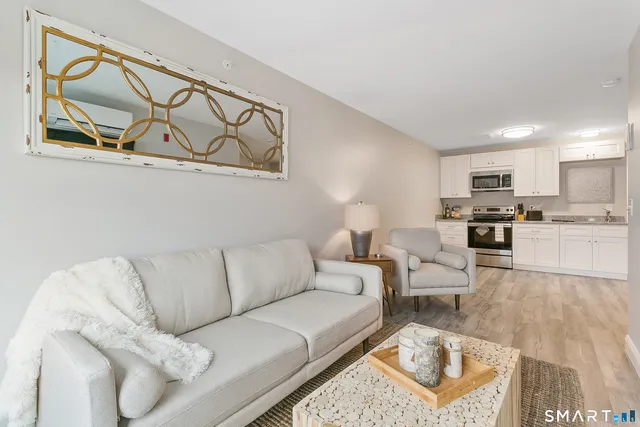 a living room with furniture and kitchen view