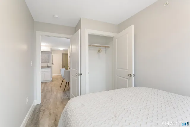 a bedroom with a bed and a bathroom