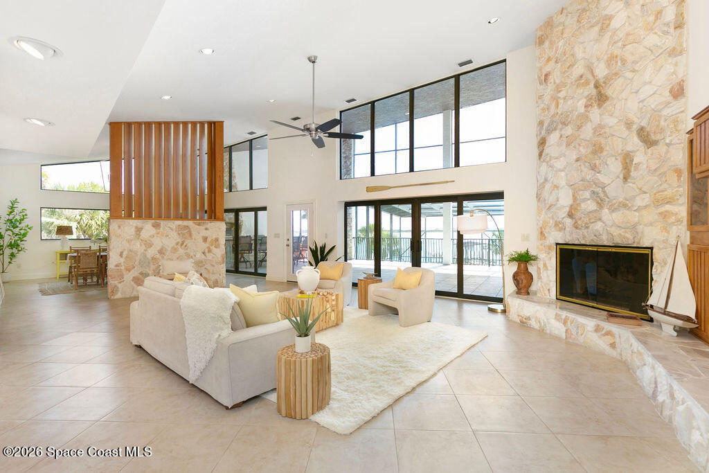 110 Barnacle Place Rockledge, FL 32955 - Photo 13 of 71 a living room with furniture a fireplace and a chandelier