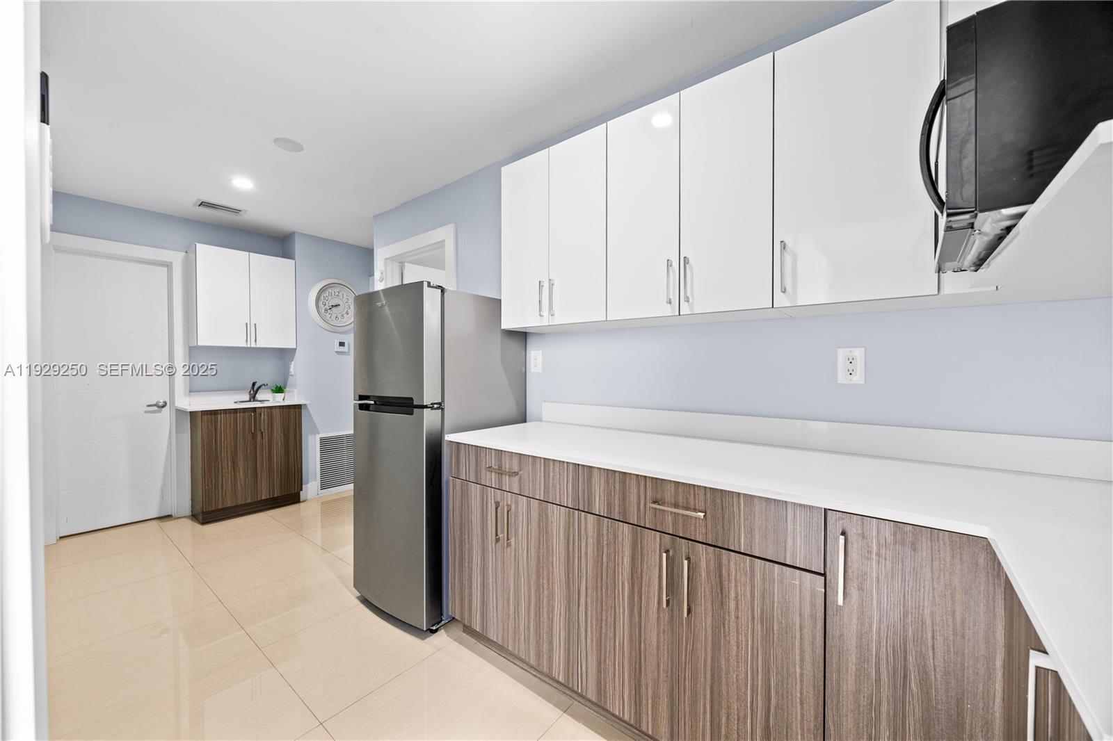 2520 Southwest 13th Street Miami, FL 33145 - Photo 11 of 26 a kitchen with a refrigerator sink and cabinets