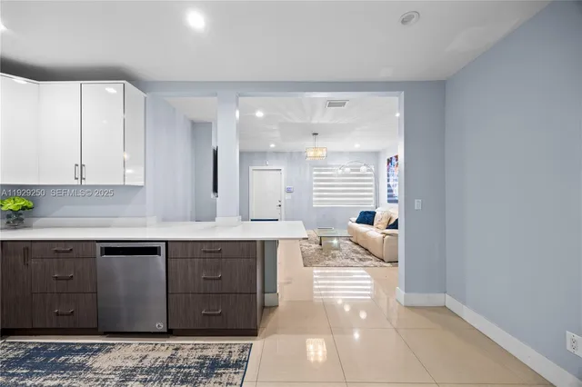 a spacious bathroom with a granite countertop sink a mirror and bathtub