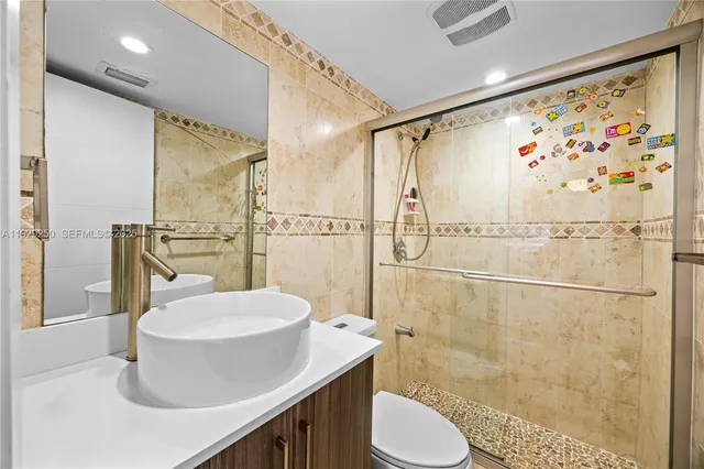 a bathroom with a sink toilet and shower