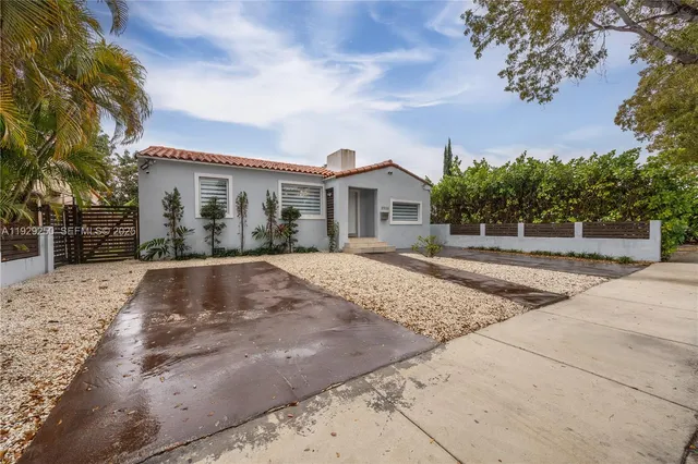 a view of a white house with a yard