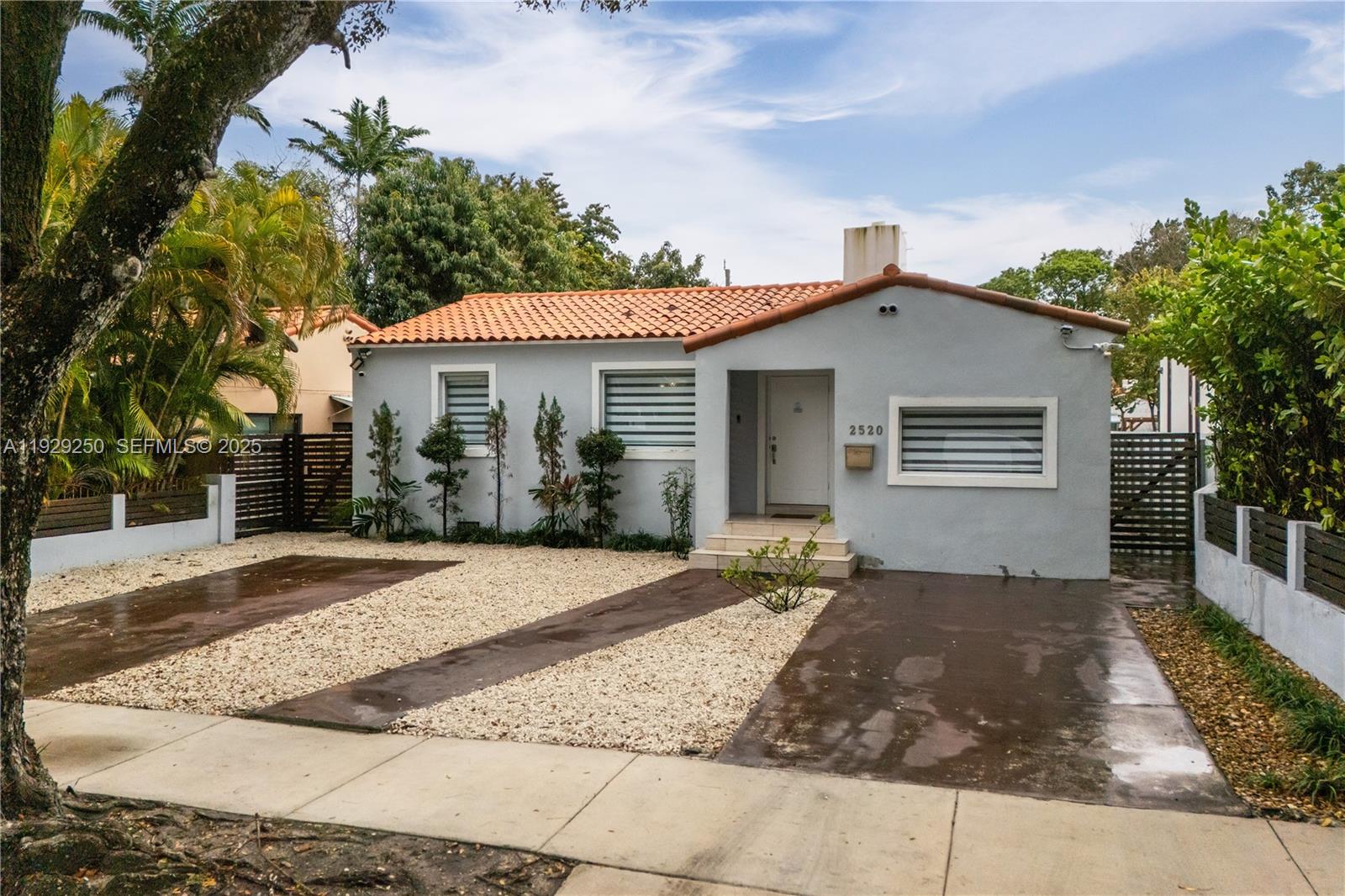2520 Southwest 13th Street Miami, FL 33145 - Photo 3 of 26 a front view of a house with a yard and garage