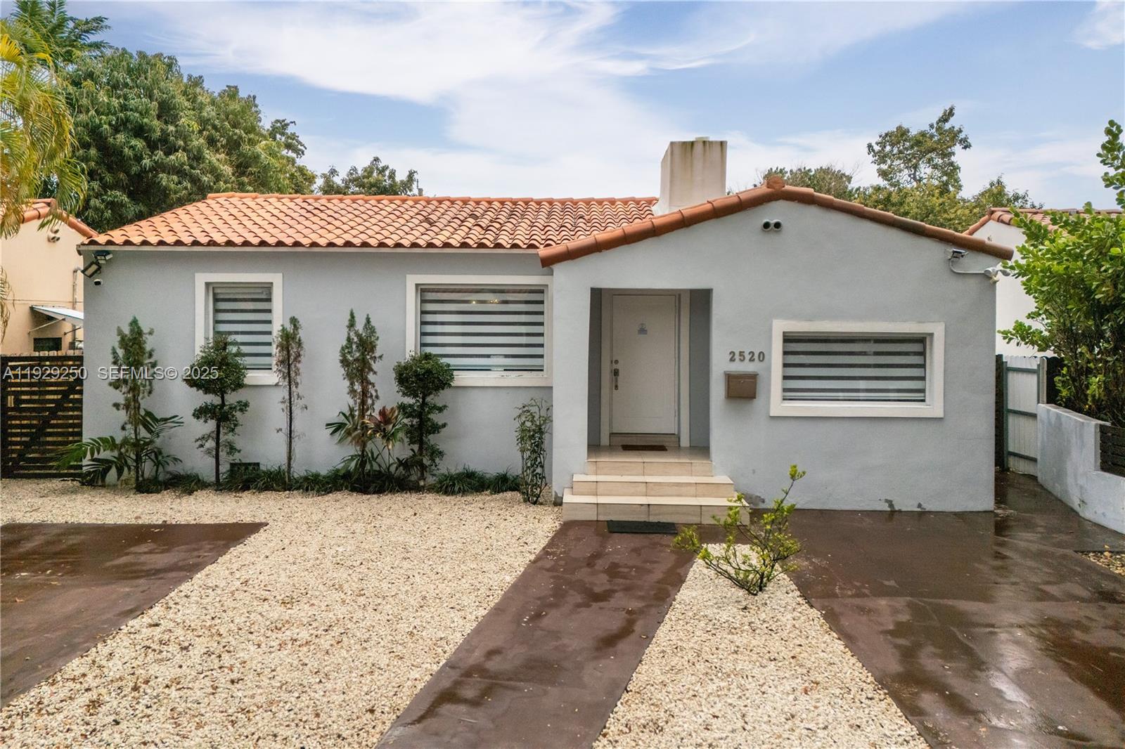 2520 Southwest 13th Street Miami, FL 33145 - Photo 4 of 26 a front view of a house with a yard and garage