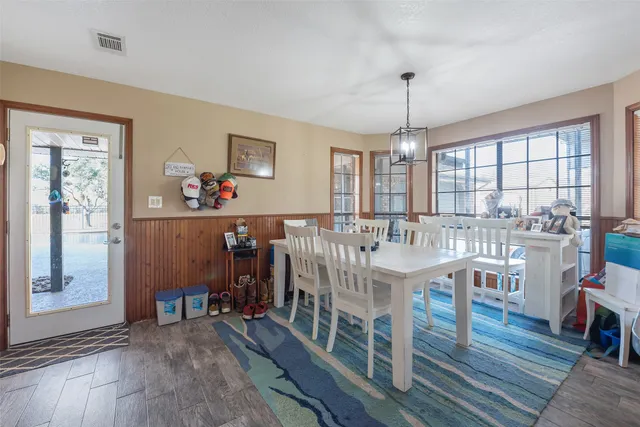 a very nice looking dining room with furniture window and wooden floor