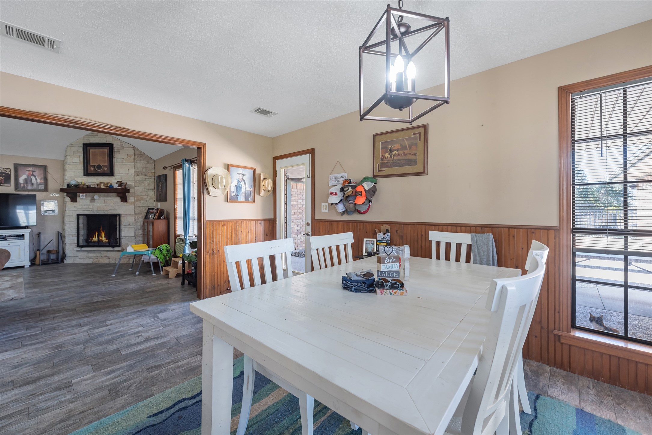 1014 Ginger Street Santa Fe, TX 77517 - Photo 12 of 50 a view of a dining room with furniture a chandelier and wooden floor