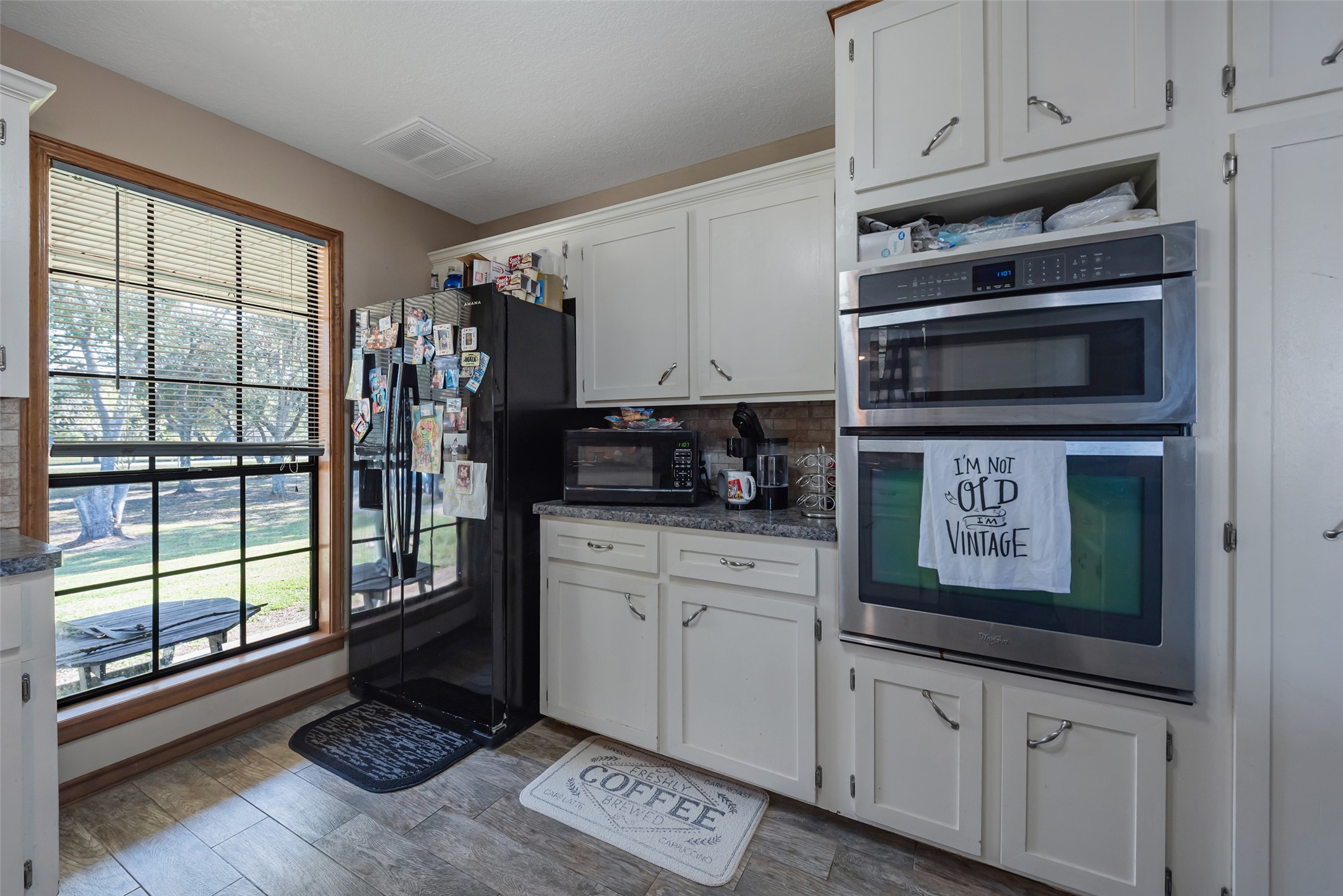 1014 Ginger Street Santa Fe, TX 77517 - Photo 15 of 50 a kitchen with stainless steel appliances granite countertop a stove a sink and a microwave