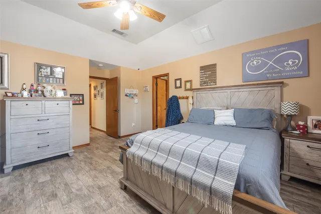 a bedroom with a bed and a chandelier