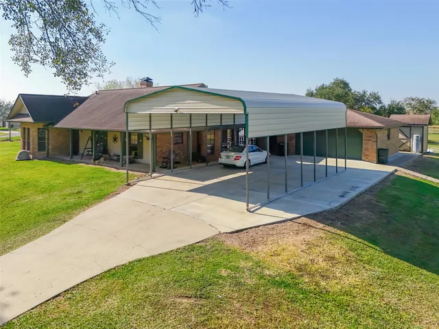 a patio with a table and chairs under an umbrella