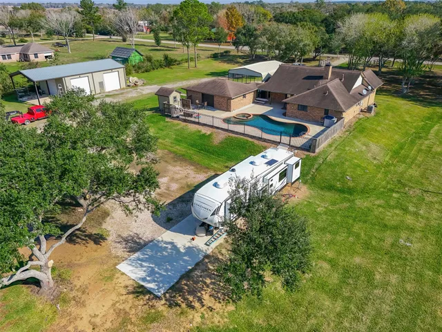 an aerial view of swimming pool with a yard