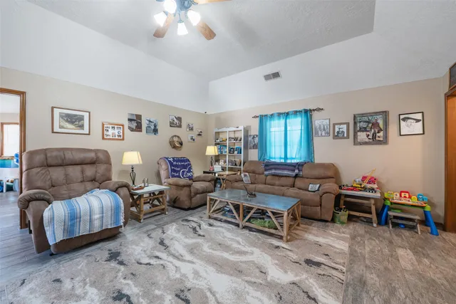a living room with furniture and a chandelier