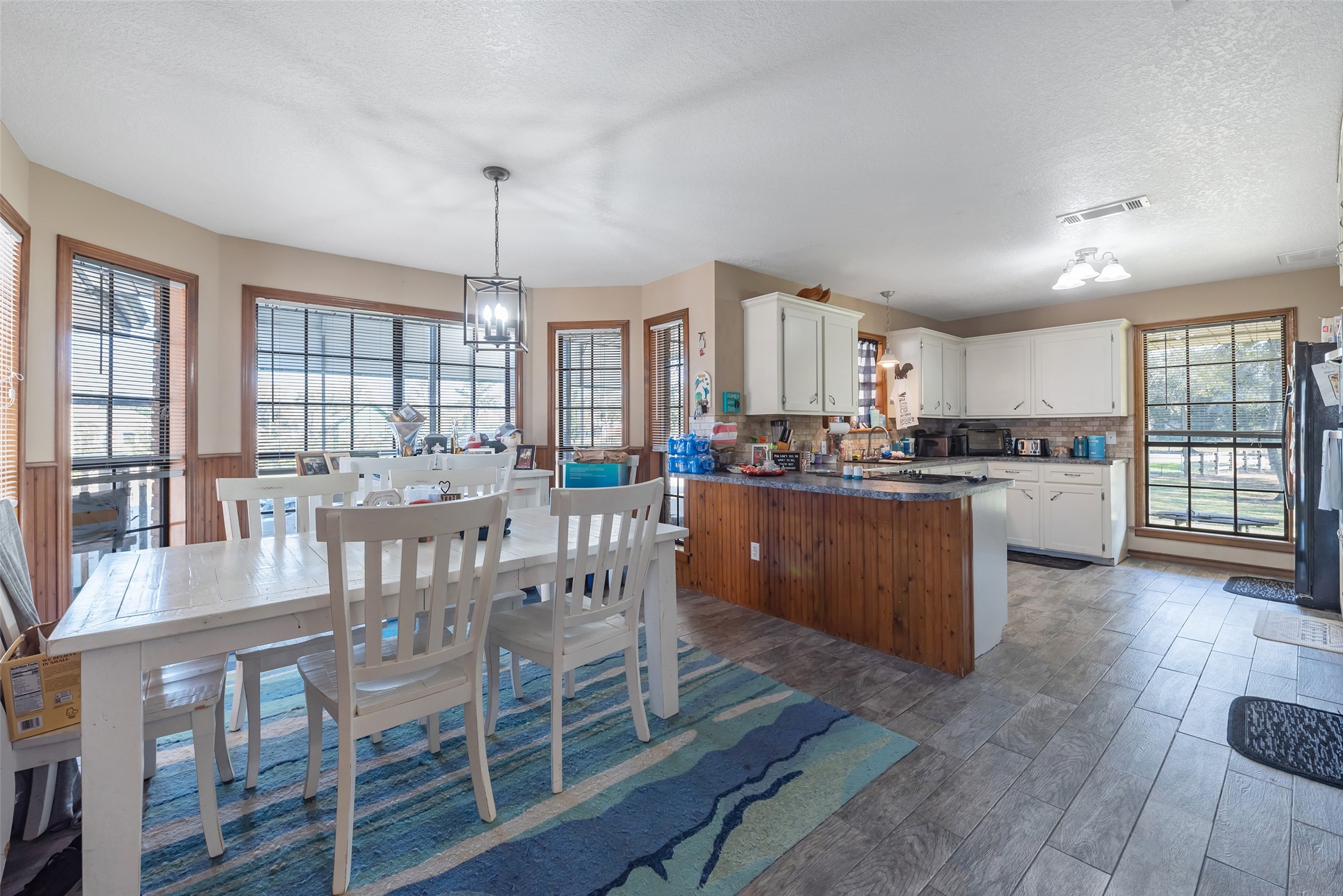 1014 Ginger Street Santa Fe, TX 77517 - Photo 10 of 50 a kitchen with stainless steel appliances granite countertop a stove a sink dishwasher a dining table and chairs with wooden floor