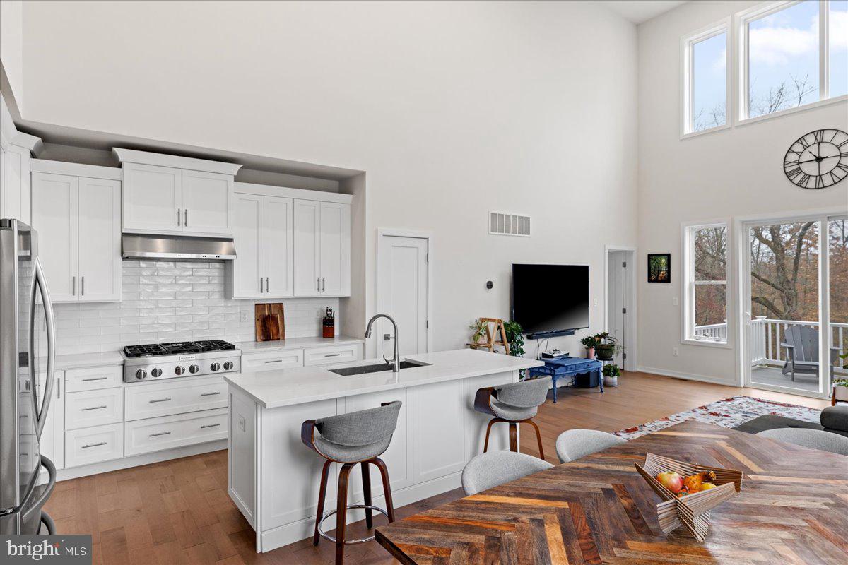 a kitchen with stainless steel appliances a stove a sink and a refrigerator