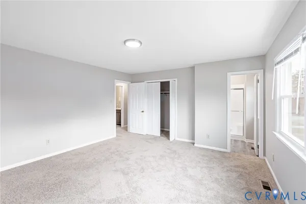 a view of an empty room and a window