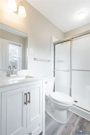 a bathroom with a toilet a sink and a large mirror
