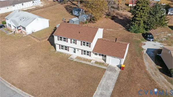an aerial view of a house with a yard