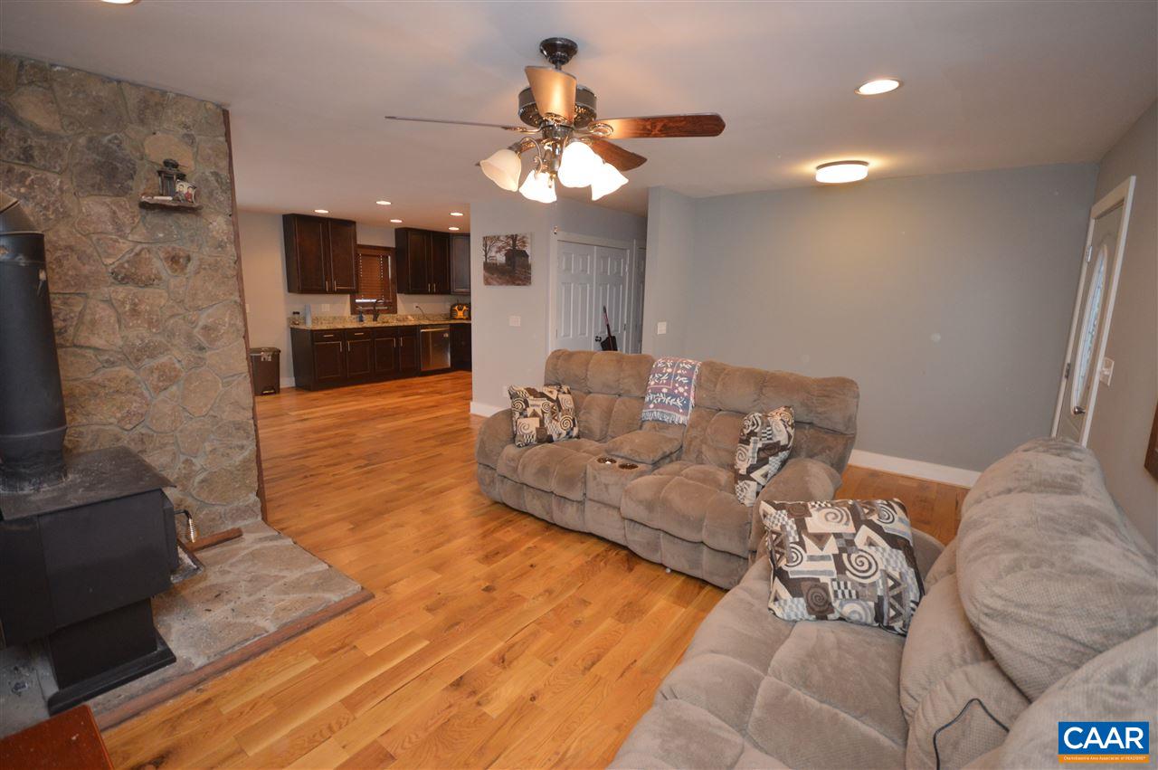 3633 Middle River Road Stanardsville, VA 22973 - Photo 11 of 26 a living room with furniture kitchen view and a chandelier
