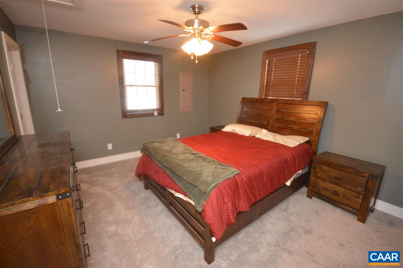 3633 Middle River Road Stanardsville, VA 22973 - Photo 15 of 26 a bedroom with a bed and a chandelier