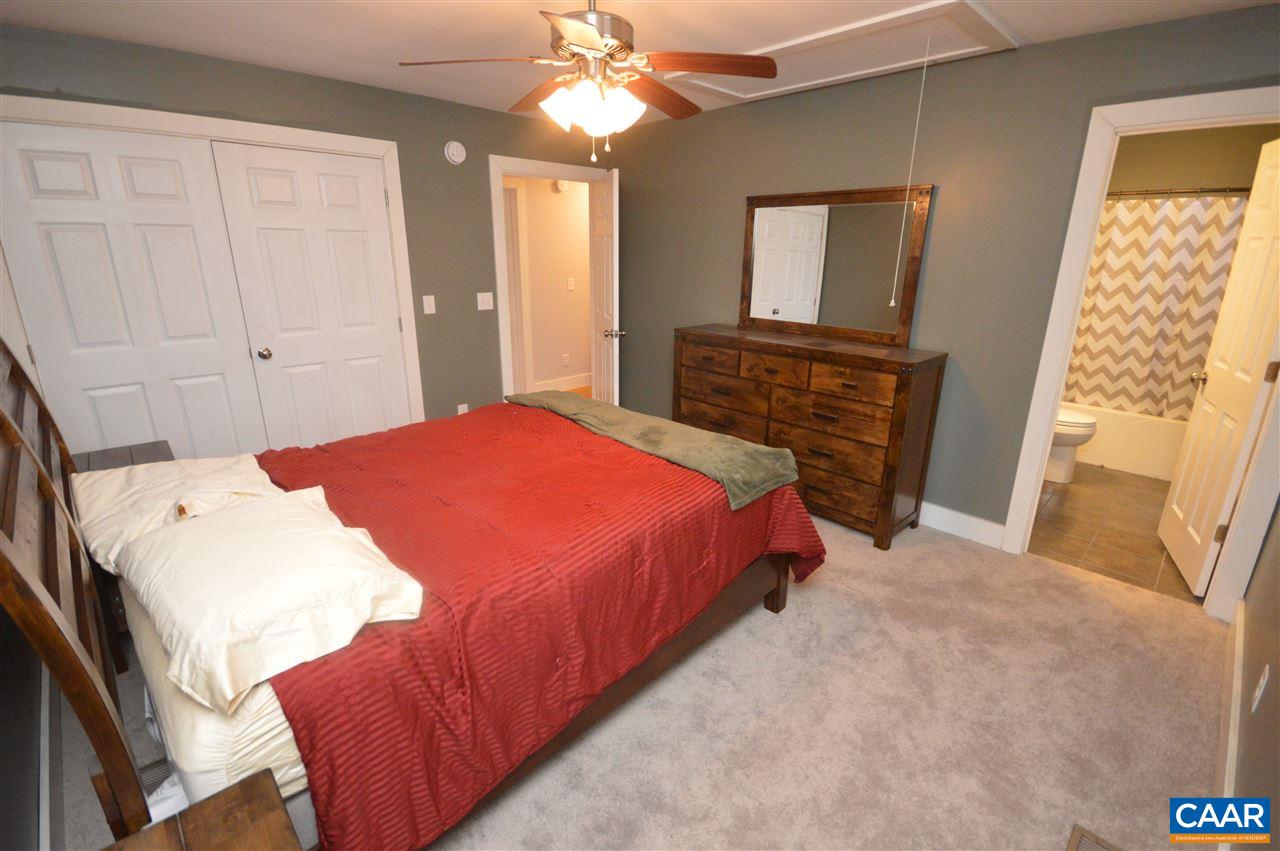 3633 Middle River Road Stanardsville, VA 22973 - Photo 17 of 26 a bedroom with a bed and a mirror on the dresser