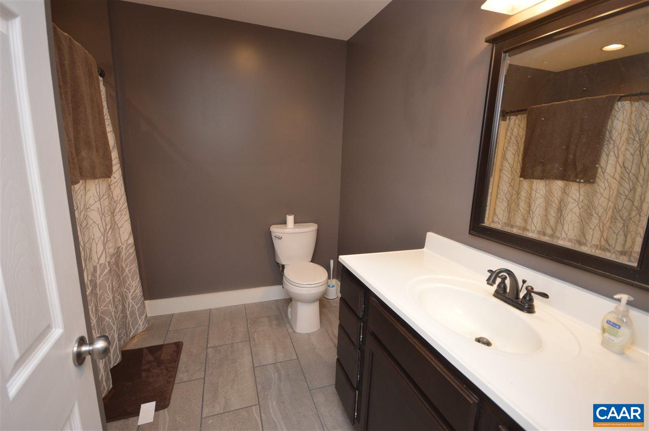 3633 Middle River Road Stanardsville, VA 22973 - Photo 19 of 26 a bathroom with a sink a toilet and mirror