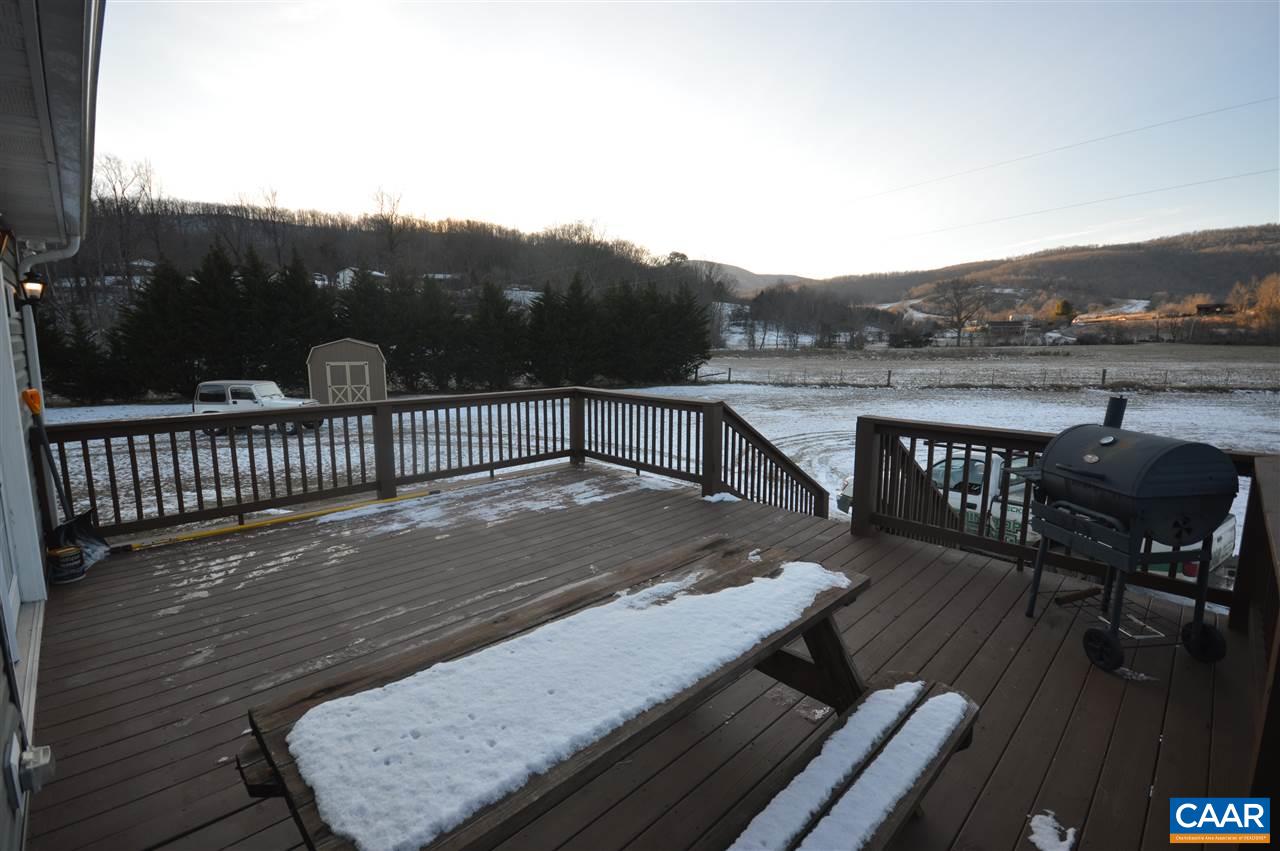 3633 Middle River Road Stanardsville, VA 22973 - Photo 6 of 26 a view of a roof deck with table and chairs and wooden floor