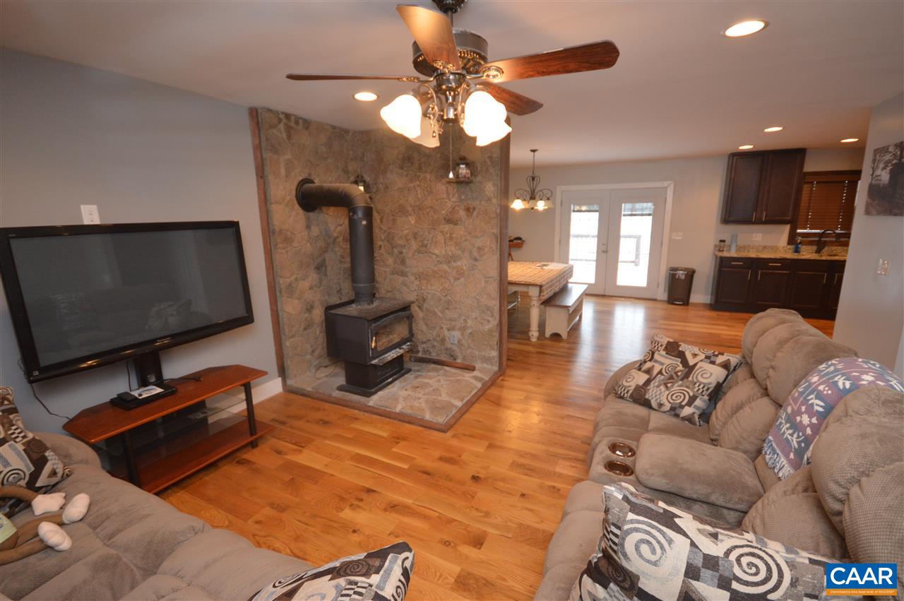 3633 Middle River Road Stanardsville, VA 22973 - Photo 7 of 26 a living room with furniture a flat screen tv and kitchen view