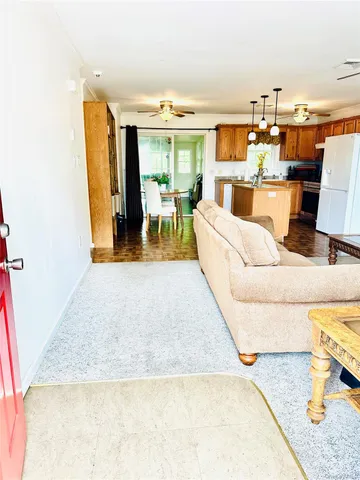 a living room with furniture and a dining table