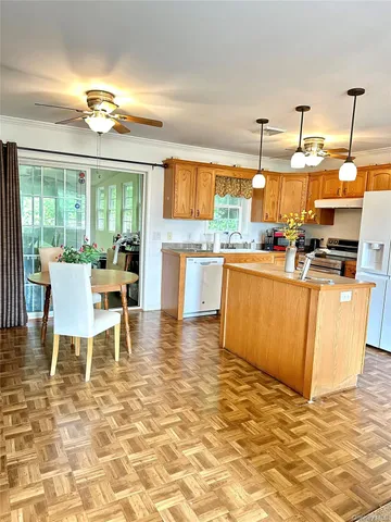 a room with kitchen island granite countertop furniture and a dining table