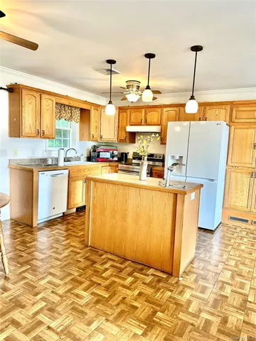 a kitchen with stainless steel appliances granite countertop a sink stove and cabinets