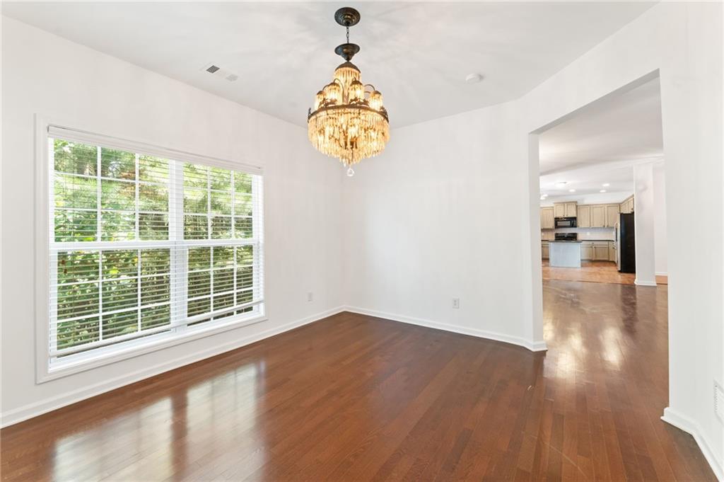 208 Sawtooth Court Canton, GA 30114 - Photo 11 of 31 a view of an empty room with wooden floor and a window