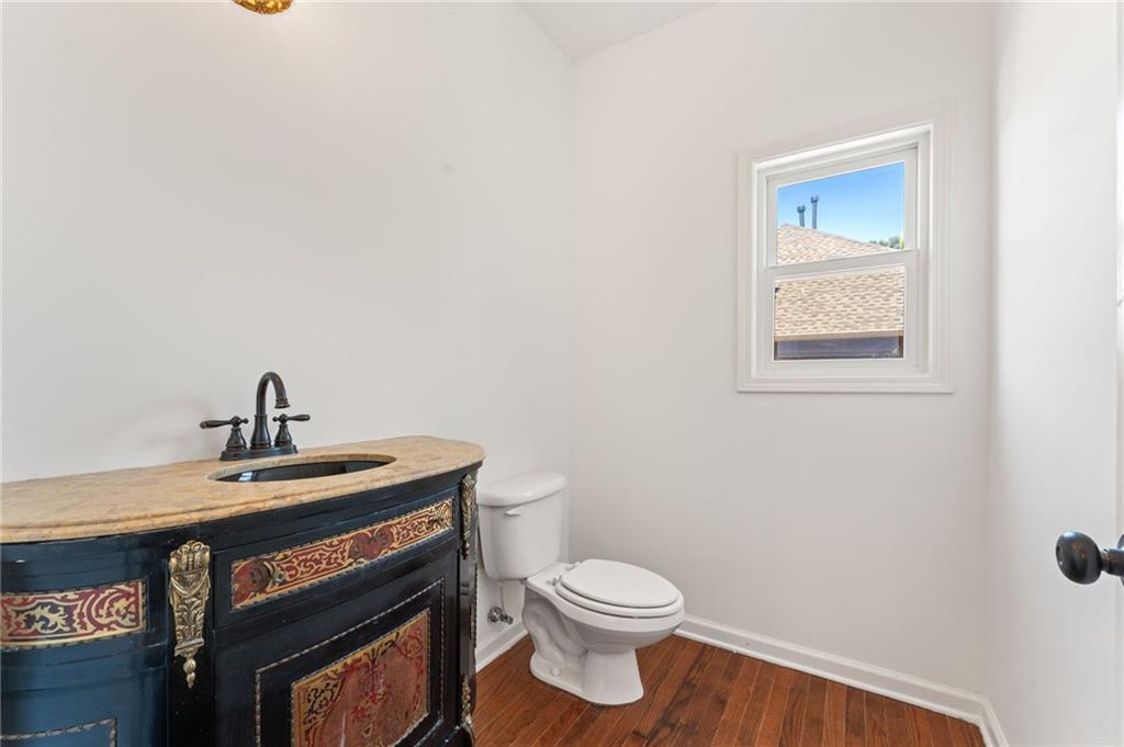 208 Sawtooth Court Canton, GA 30114 - Photo 17 of 31 a bathroom with a toilet a sink and mirror