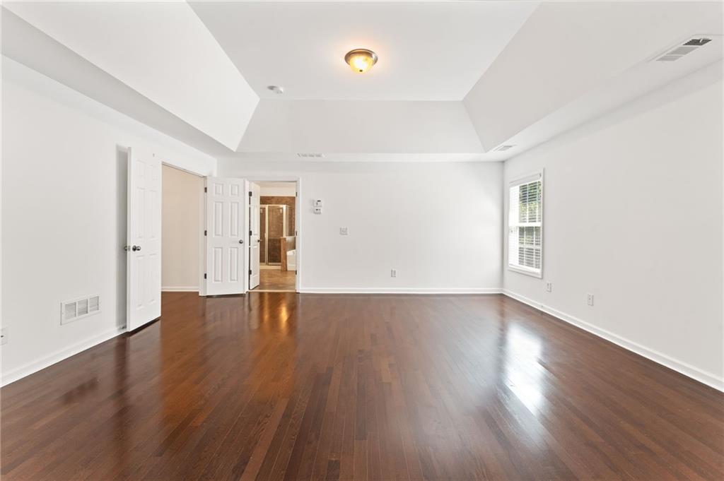 208 Sawtooth Court Canton, GA 30114 - Photo 19 of 31 an empty room with wooden floor and windows