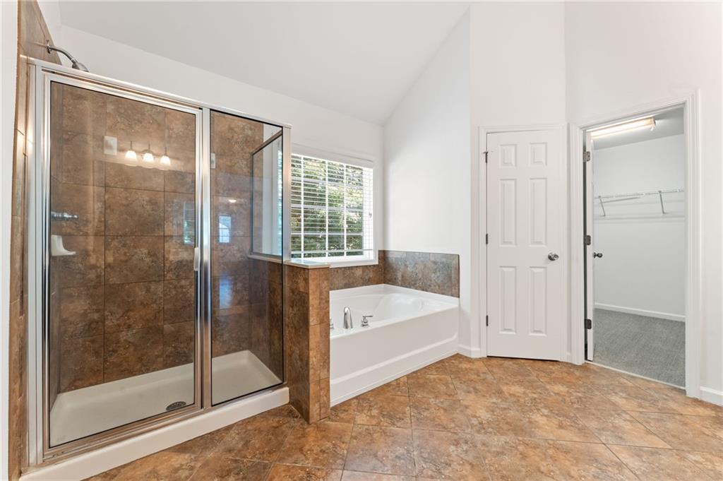 208 Sawtooth Court Canton, GA 30114 - Photo 22 of 31 a bathroom with a bathtub and a shower