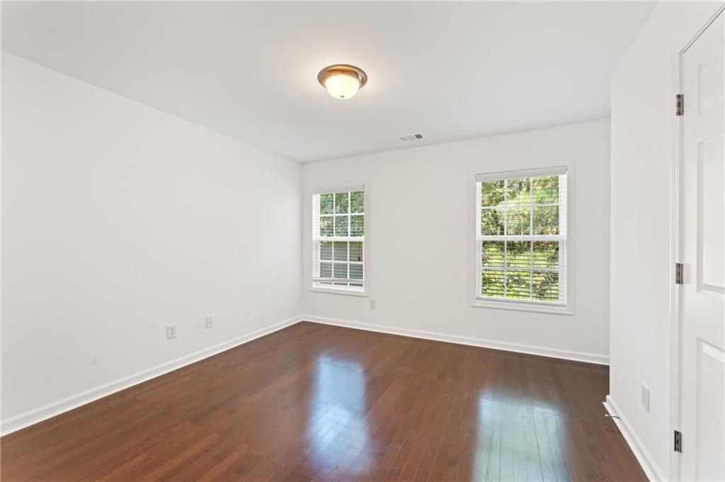 208 Sawtooth Court Canton, GA 30114 - Photo 24 of 31 an empty room with wooden floor and windows
