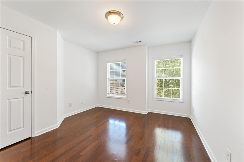 208 Sawtooth Court Canton, GA 30114 - Photo 29 of 31 an empty room with wooden floor and windows