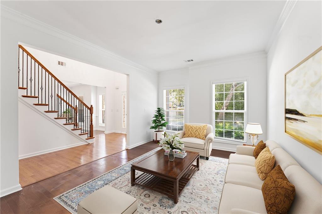 208 Sawtooth Court Canton, GA 30114 - Photo 7 of 31 a living room with furniture and a table with wooden floor