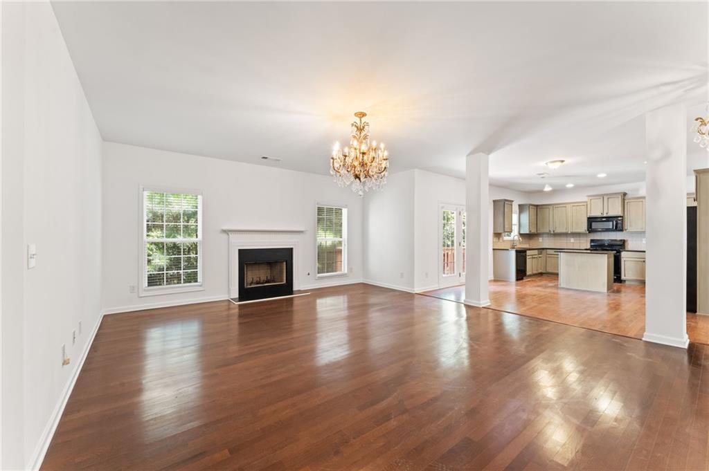 208 Sawtooth Court Canton, GA 30114 - Photo 10 of 31 a view of a hallway with wooden floor and a kitchen