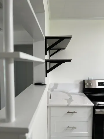 an empty room with wooden floor and a window
