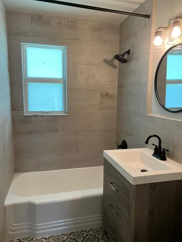 a bathroom with a sink a toilet and bathtub