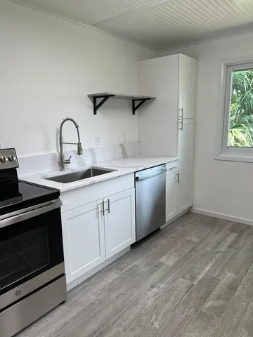 a kitchen with a sink cabinets and appliances