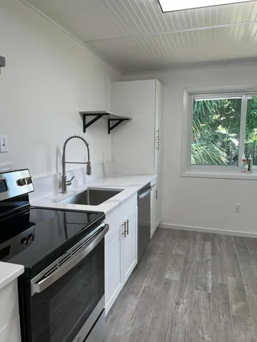 a kitchen that has a sink and a stove