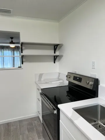 a stove top oven sitting inside of a kitchen