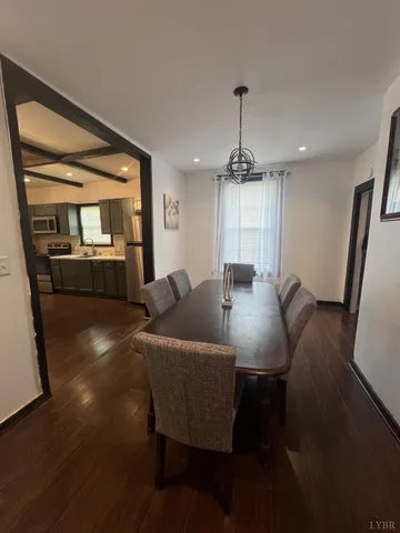 a view of a dining room with furniture wooden floor and chandelier