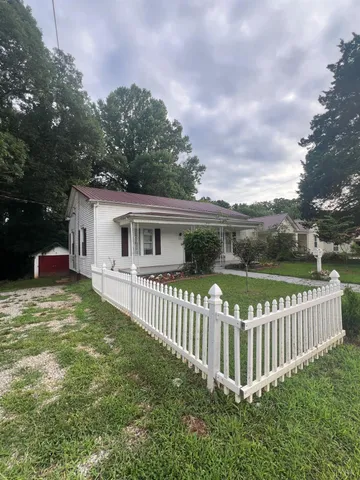 a view of a house with backyard and porch