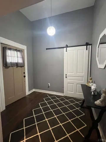 a view of a livingroom with wooden floor and a window