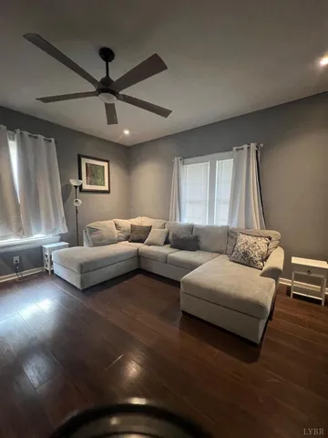 a bedroom with furniture and a large window