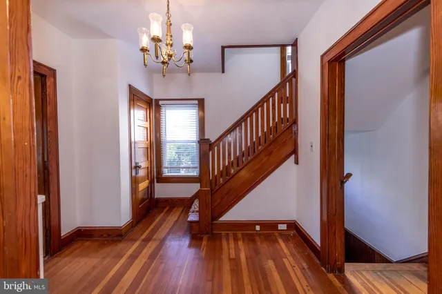 a view of entryway and hall with wooden floor