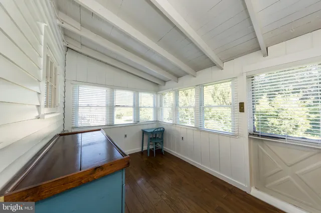 a view of a kitchen with an oven and wooden floor